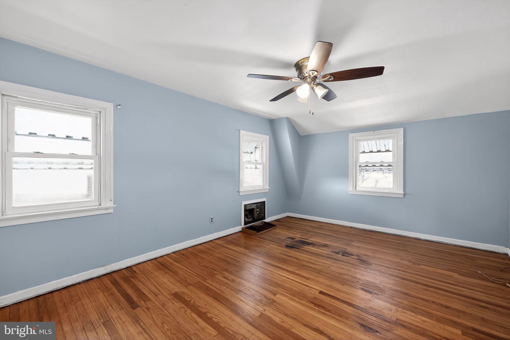 1212 Meadow Road Woodlyn, PA 19094 - Photo 9 of 30 a view of empty room with wooden floor and fan