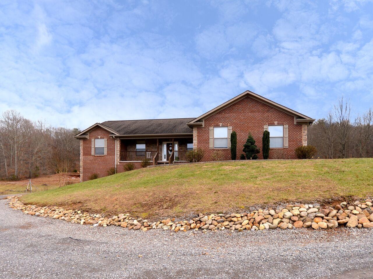 1013 Blockhouse Valley Road Clinton, TN 37716 - Photo 1 of 37 a front view of a house with a yard