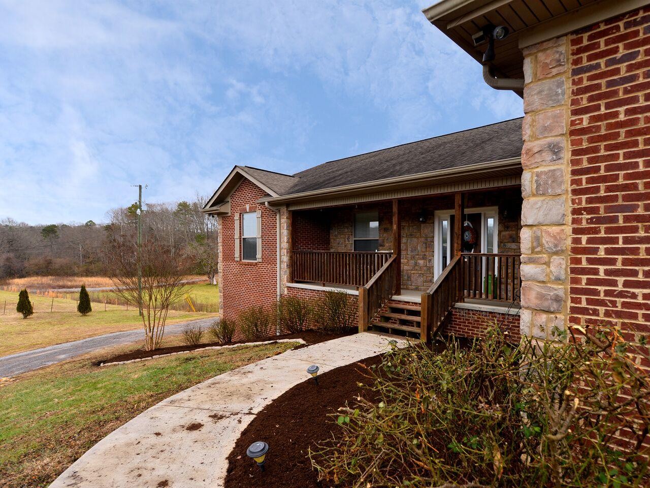1013 Blockhouse Valley Road Clinton, TN 37716 - Photo 3 of 37 a front view of a house with a yard