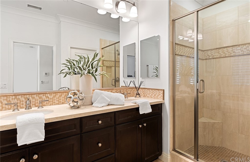 62 Cipresso Irvine, CA 92618 - Photo 17 of 49 a bathroom with a double vanity sink mirror and shower