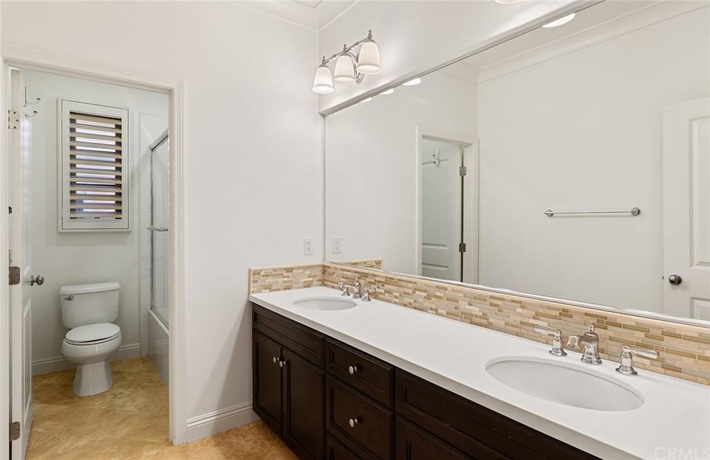 62 Cipresso Irvine, CA 92618 - Photo 21 of 49 a spacious bathroom with a granite countertop sink a toilet and a large mirror