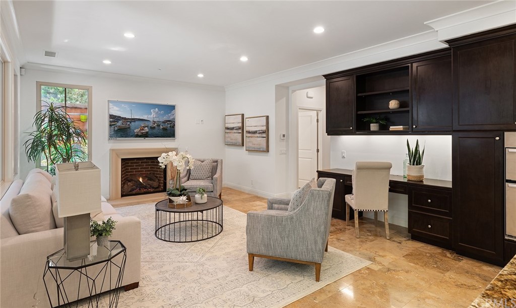 62 Cipresso Irvine, CA 92618 - Photo 8 of 49 a living room with furniture a flat screen tv and a fireplace