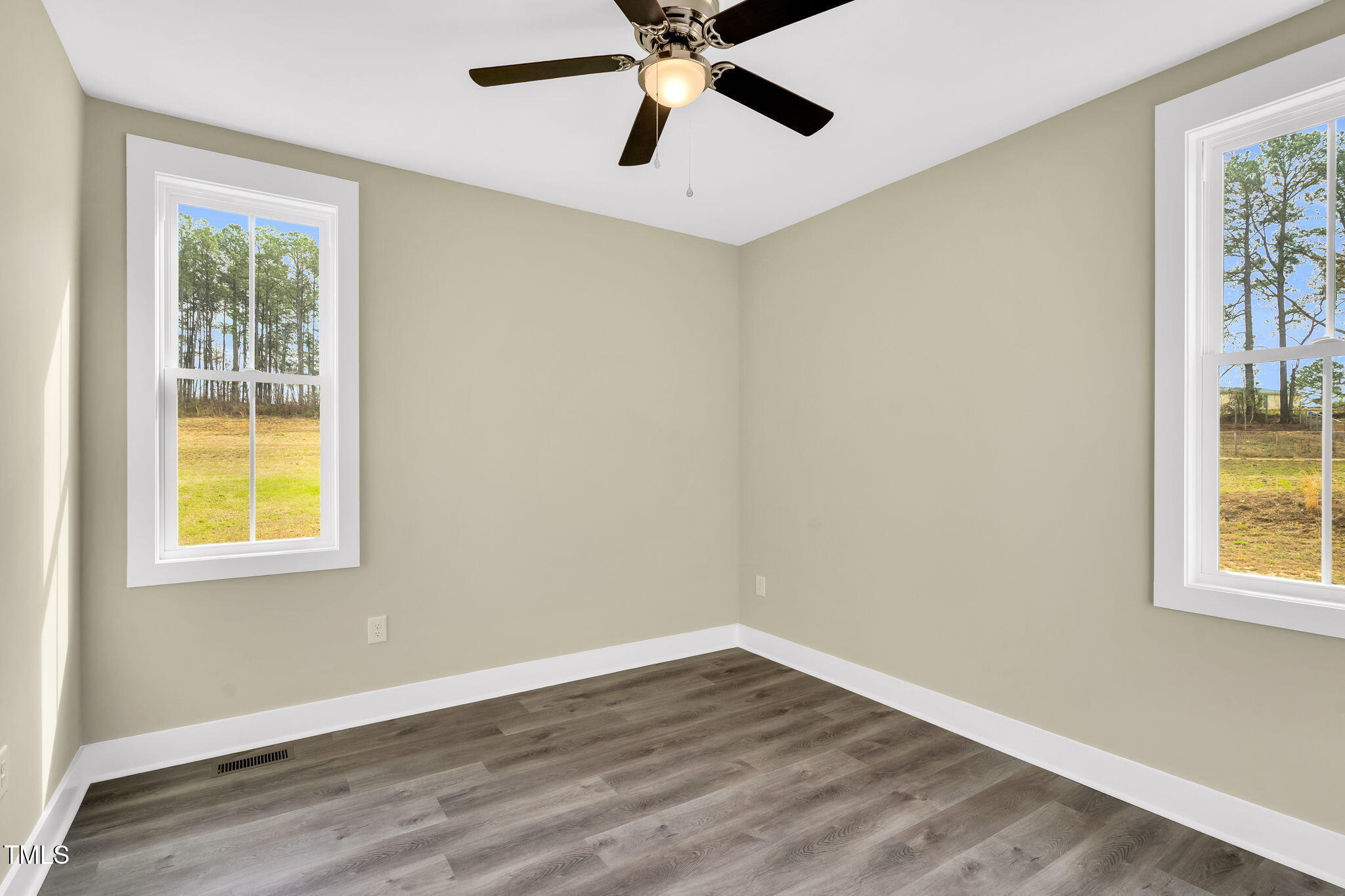 1076 Highway 55 Coats, NC 27521 - Photo 17 of 20 a view of an empty room with wooden floor and a window