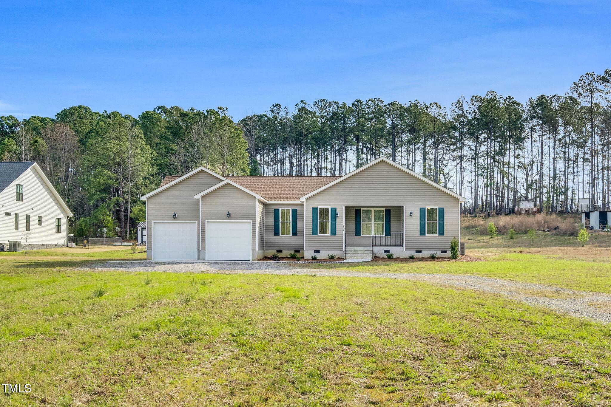 1076 Highway 55 Coats, NC 27521 - Photo 2 of 20 a front view of a house with a yard