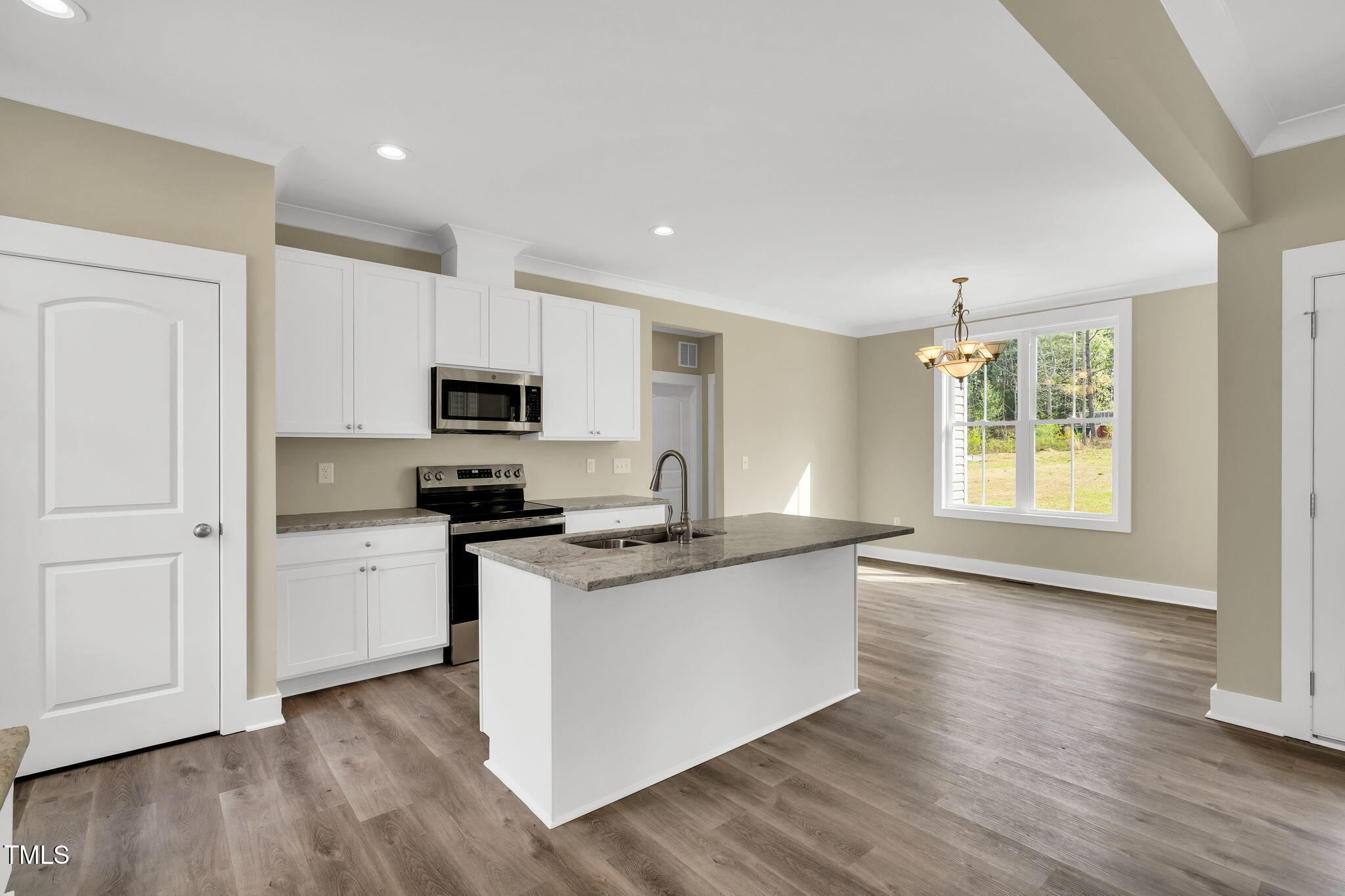1076 Highway 55 Coats, NC 27521 - Photo 4 of 20 a kitchen with granite countertop a stove and a wooden floors