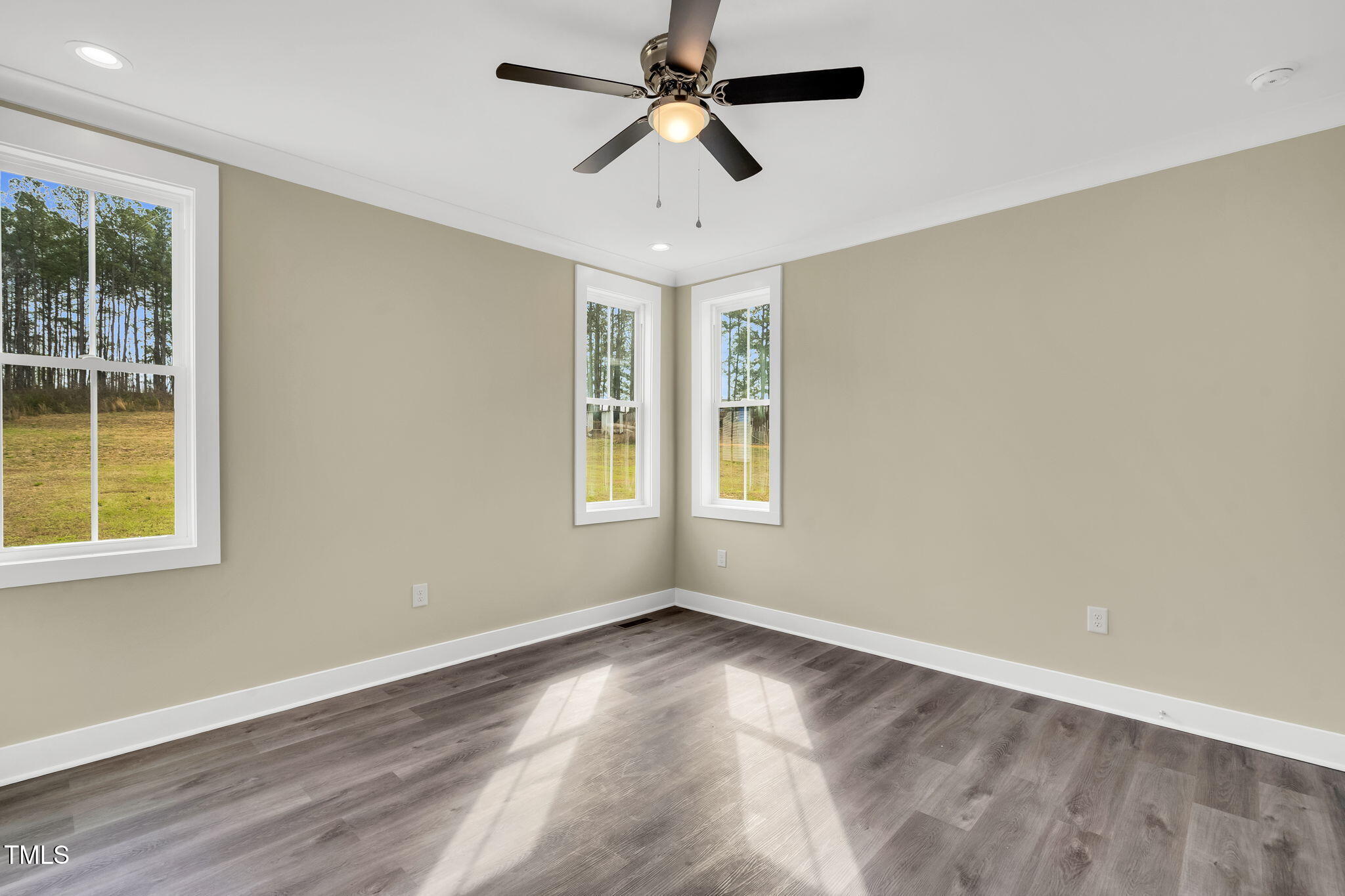 1076 Highway 55 Coats, NC 27521 - Photo 9 of 20 an empty room with windows and ceiling fan