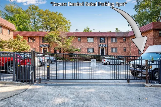 a view of a brick house with a wooden deck and a floor to ceiling window