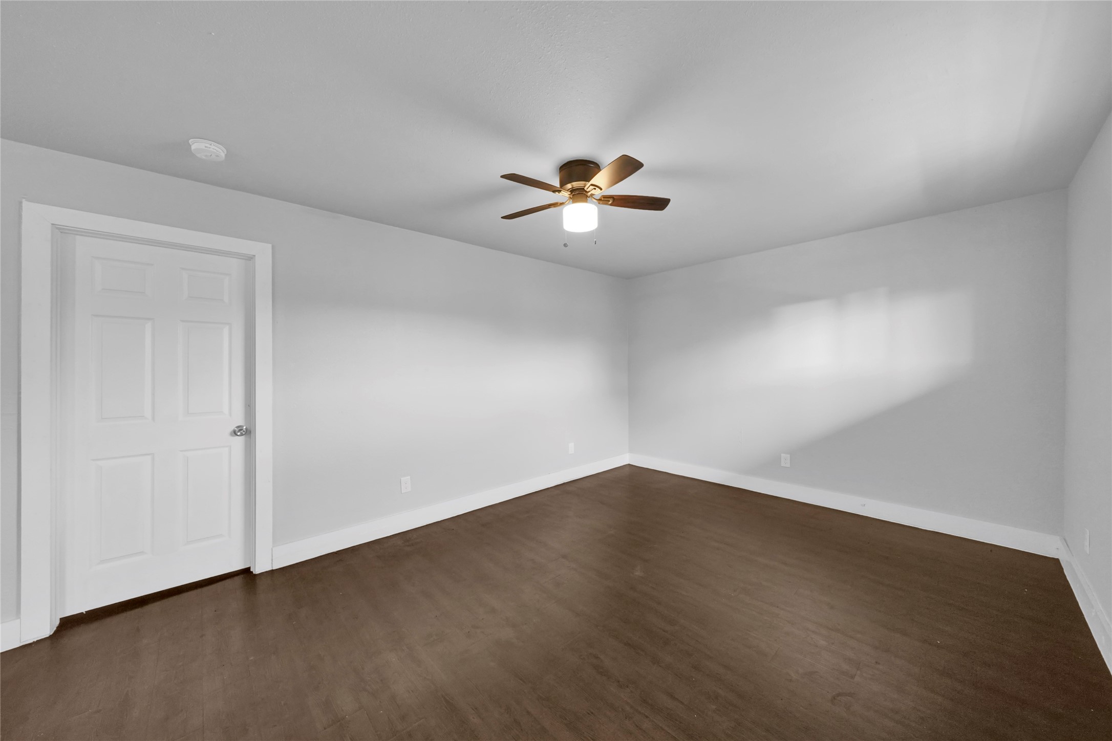 6518 Weston Street, Unit 11 Houston, TX 77021 - Photo 1 of 15 a view of an empty room with a ceiling fan and wooden floor