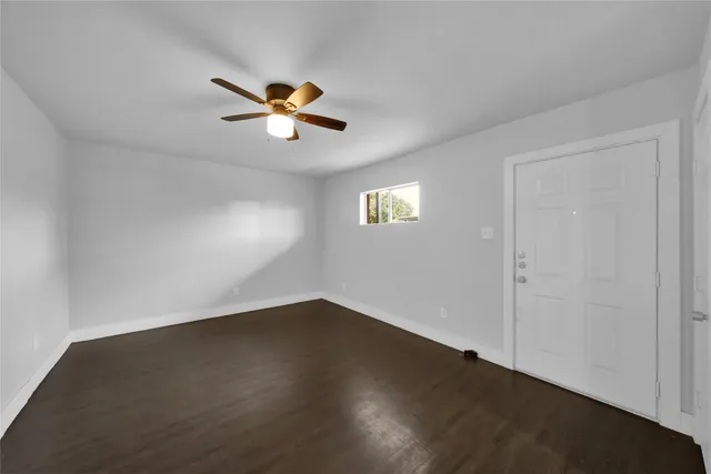 a view of a room with a ceiling fan and a window