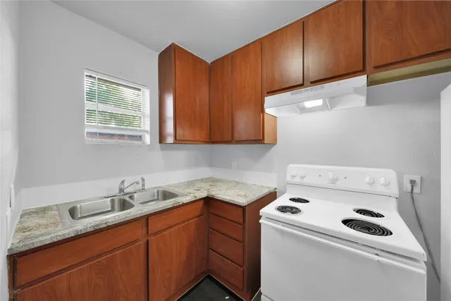 a utility room with sink dryer and washer