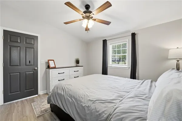 a bedroom with a bed and a chandelier