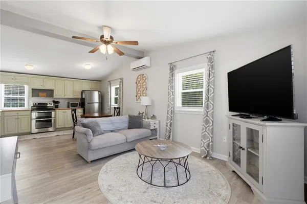 a living room with furniture and a flat screen tv