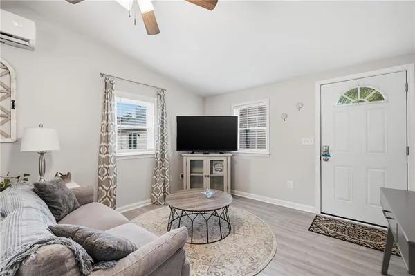 a living room with furniture and a flat screen tv