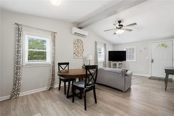 a view of a livingroom with furniture and a flat screen tv