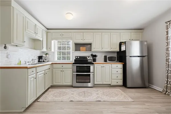 a kitchen with a refrigerator sink and microwave