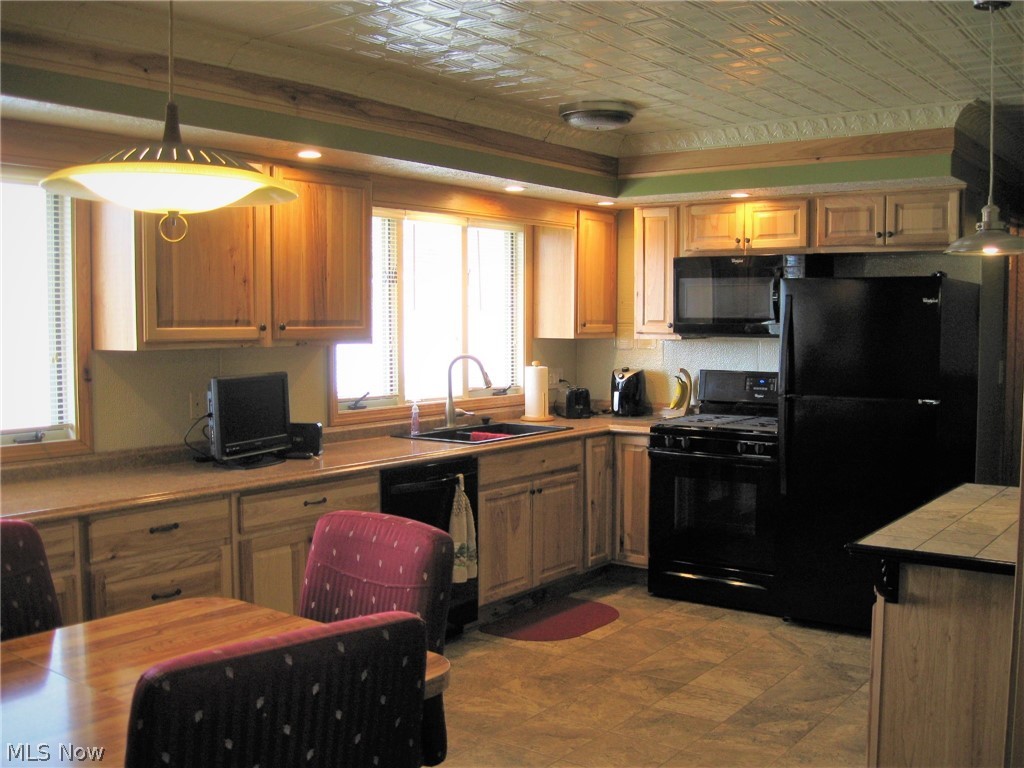 9108 Spencer Road Homerville, OH 44235 - Photo 6 of 14 The remodeled Hickory kitchen features a tin ceiling and ceramic floor. All kitchen appliances stay.