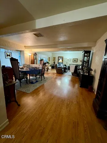 a dining room with furniture a rug a fireplace and a chandelier