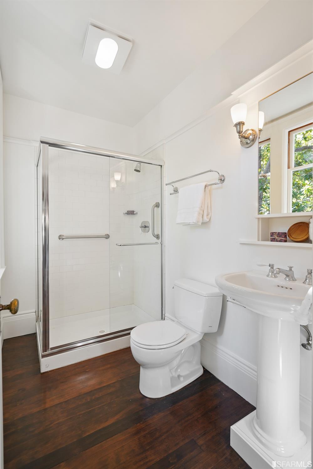 1314 Arch Street Berkeley, CA 94708 - Photo 20 of 90 a bathroom with a toilet a sink and a large mirror