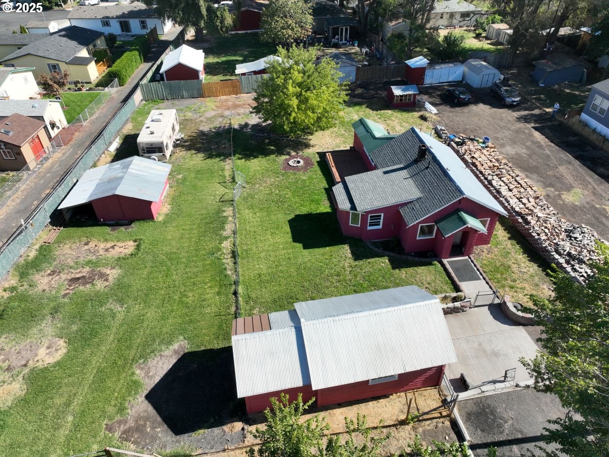 an aerial view of a house with garden space and street view