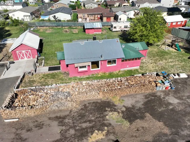 an aerial view of residential houses with outdoor space and swimming pool