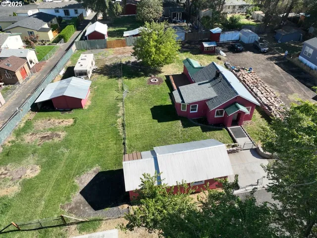 an aerial view of a house with a garden and lake view