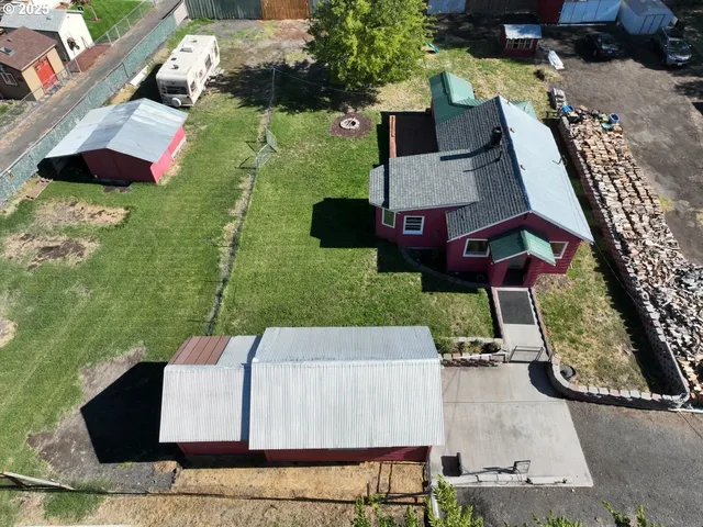 an aerial view of a house with garden space and street view