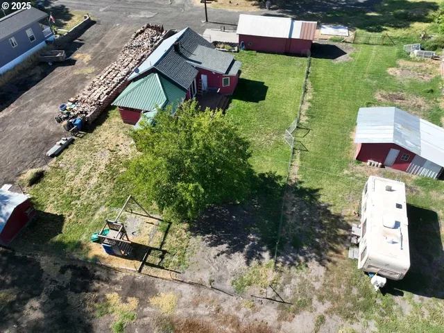 an aerial view of a house with a yard and lake view