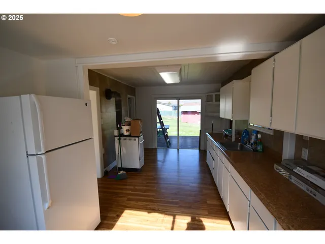 a kitchen with a refrigerator and a stove