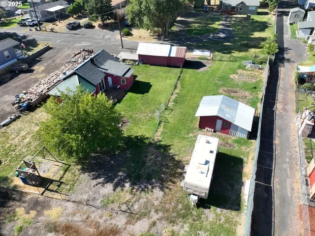 an aerial view of a house with a yard basket ball court and outdoor seating