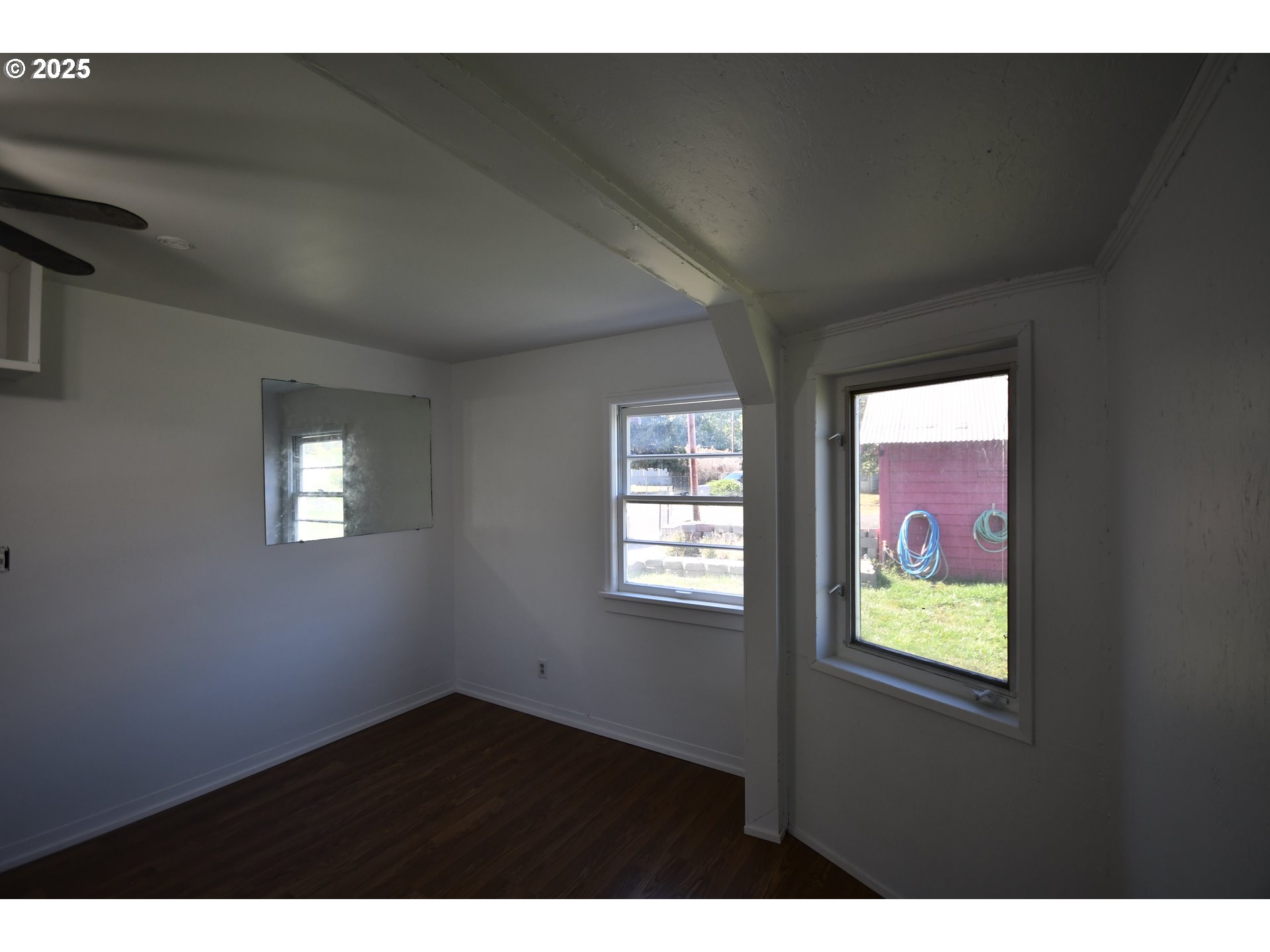 2829 West 9th Street The Dalles, OR 97058 - Photo 43 of 45 a view of an empty room with wooden floor and windows