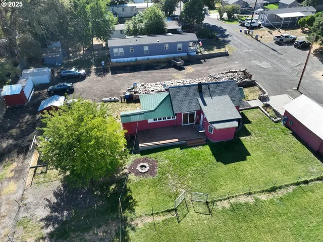 an aerial view of a house with yard swimming pool and outdoor seating