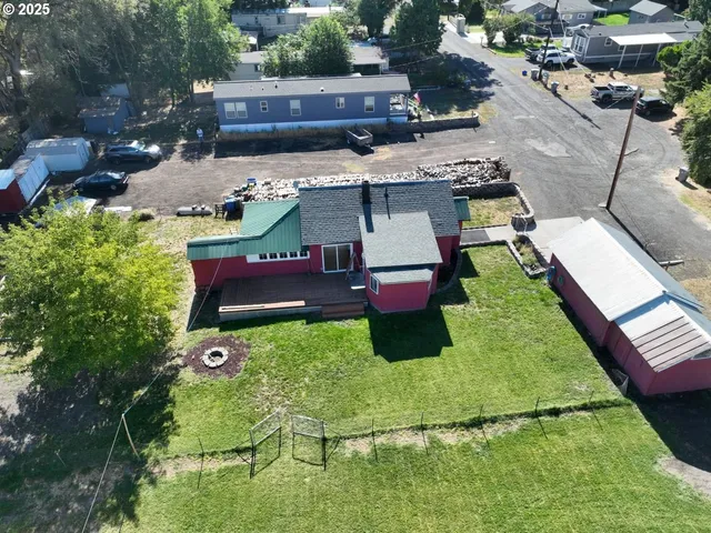 an aerial view of a house with garden space and street view