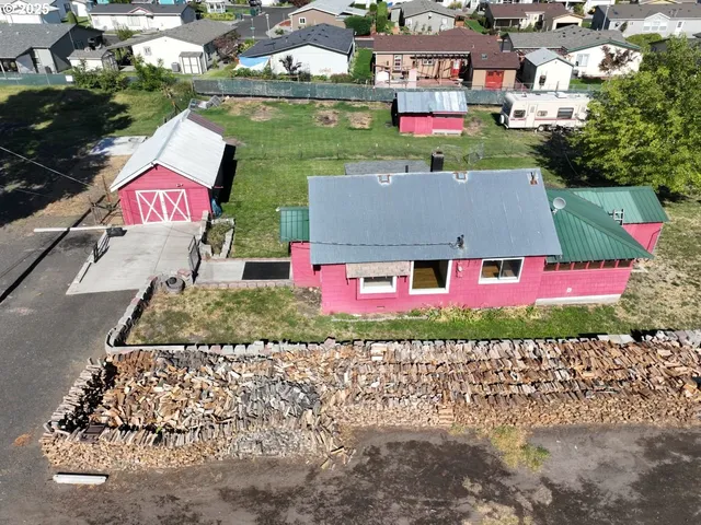an aerial view of residential houses with outdoor space and street view