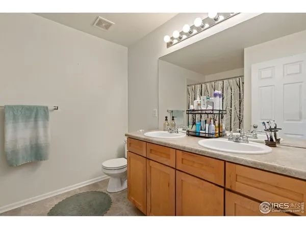 a bathroom with a sink a toilet and mirror