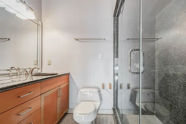 a bathroom with a toilet sink and shower