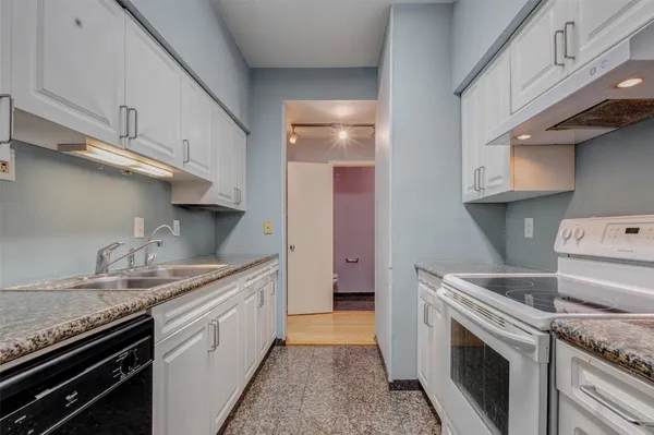 a kitchen with stainless steel appliances granite countertop a sink stove and cabinets
