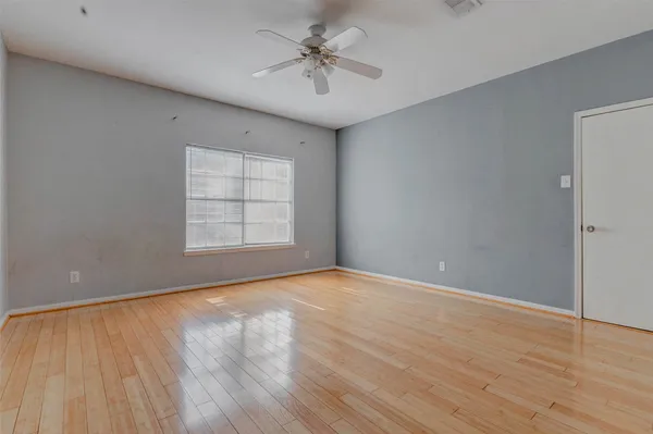 wooden floor in an empty room with a window