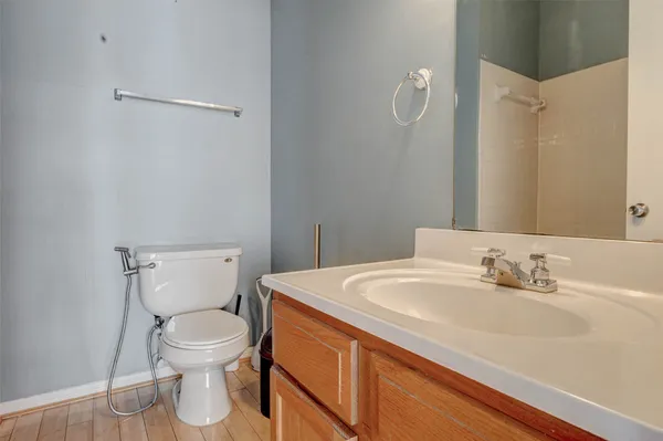 a bathroom with a sink a toilet and a mirror