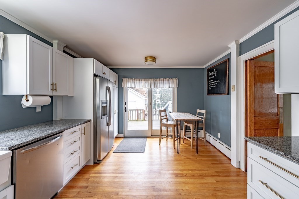 24 Manchester Terrace Springfield, MA 01108 - Photo 20 of 38 a large kitchen with stainless steel appliances granite countertop a refrigerator a stove and a wooden floors