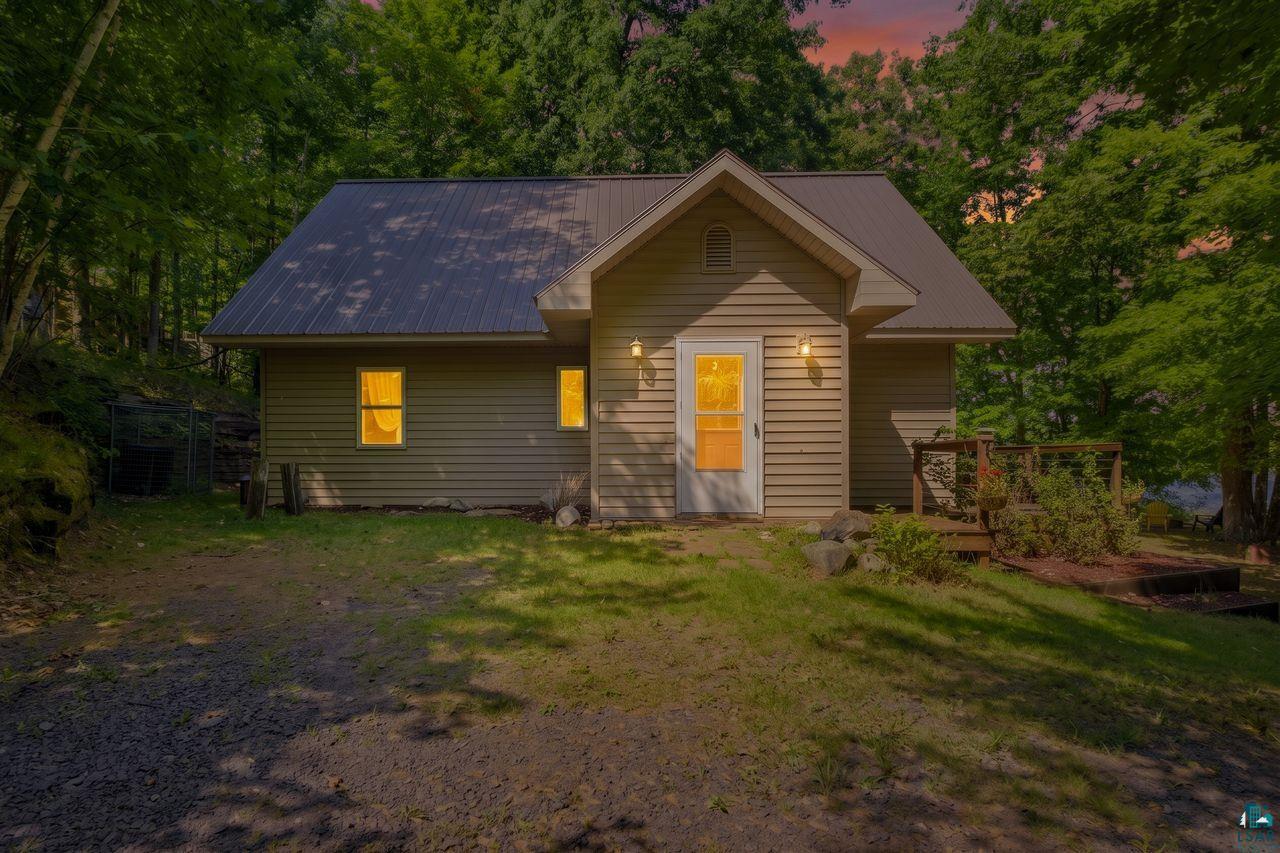69085 East Long Lake Road Iron River, WI 54847 - Photo 1 of 33 Siding exterior with a dark metal roof