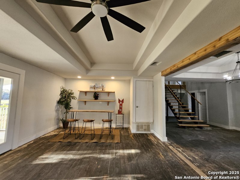 15285 South Skaggs Road Atascosa, TX 78002 - Photo 13 of 36 a living room with a couch and a chandelier