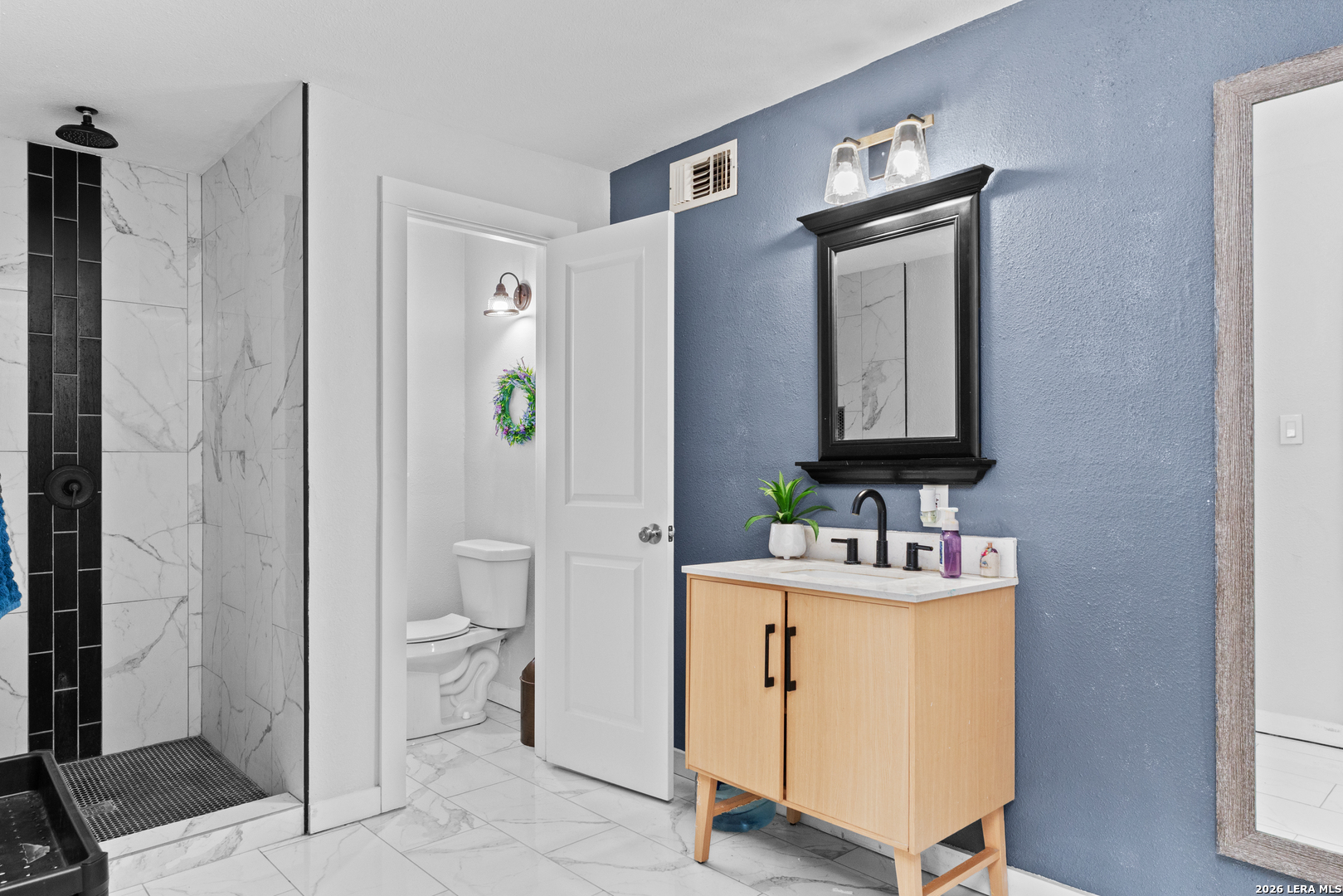 15285 South Skaggs Road Atascosa, TX 78002 - Photo 16 of 36 a bathroom with a toilet sink and shower