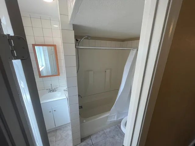 a bathroom with a tub and a shower