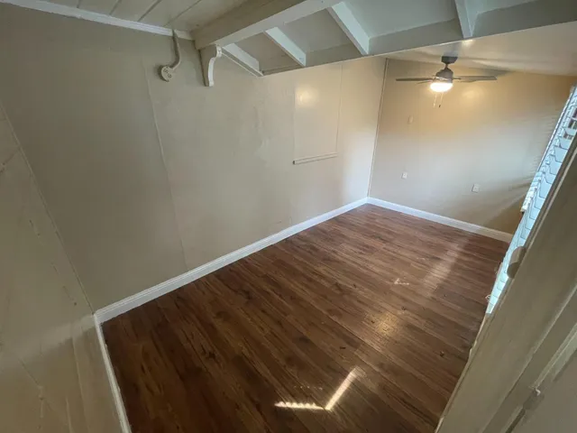 a view of room with wooden floor