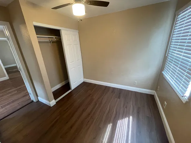 wooden floor in an empty room with a window