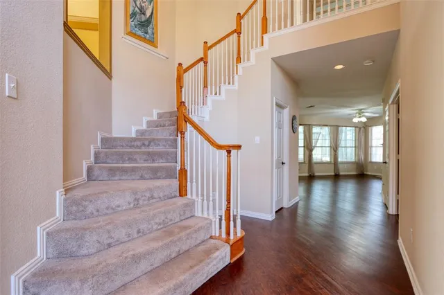 a view of staircase with lots of frames and wooden floor