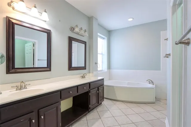 a bathroom with a tub sink double and mirror