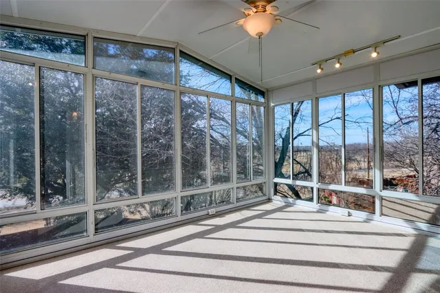a bedroom with a large bed and a large window