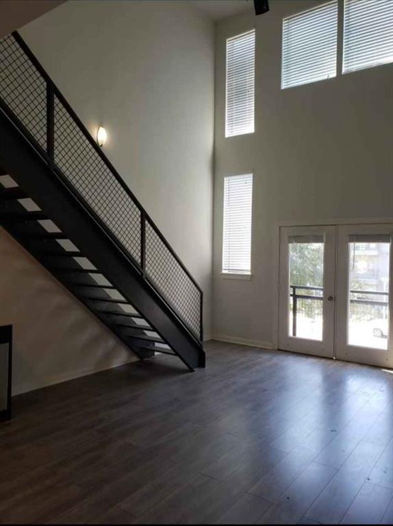 1910 Bennett Avenue Dallas, TX 75206 - Photo 6 of 9 a view of an empty room with wooden floor and a window