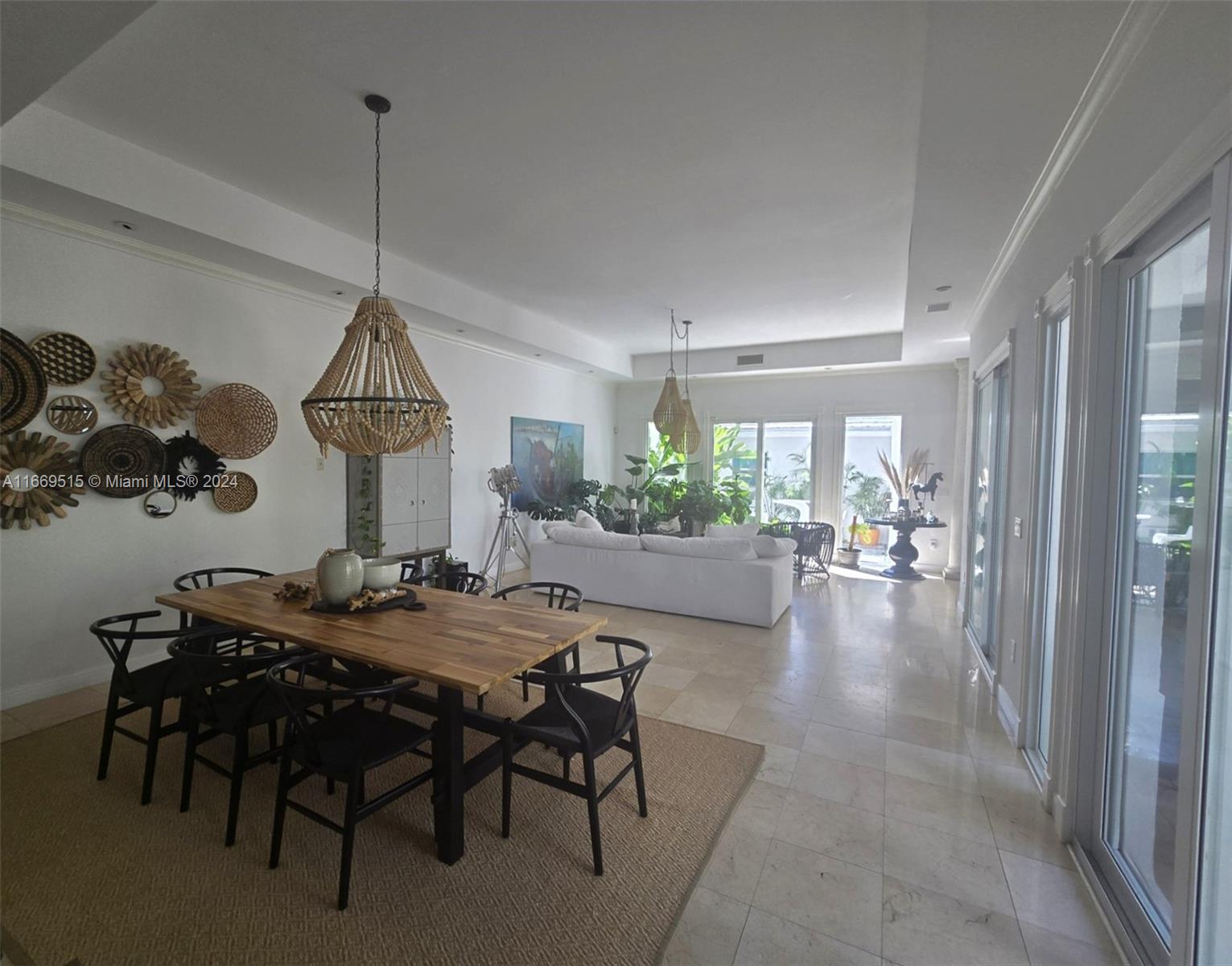 4 Turtle Walk, Unit 4 Key Biscayne, FL 33149 - Photo 11 of 29 a view of a dining room and livingroom with furniture wooden floor a chandelier